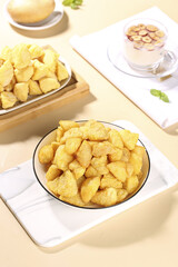 Crispy Golden Potato Snacks in Bowl on Wooden Table with Tea Setup