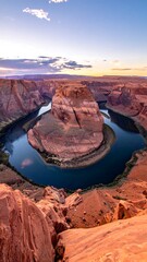 Dramatic landscape of horseshoe-shaped bend in canyon at sunset, scenic overlook, blue river