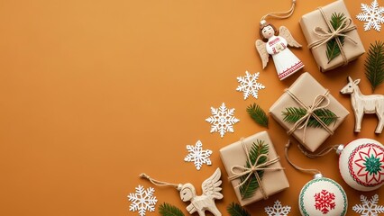 Festive christmas arrangement with gifts ornaments and snowflakes on orange background