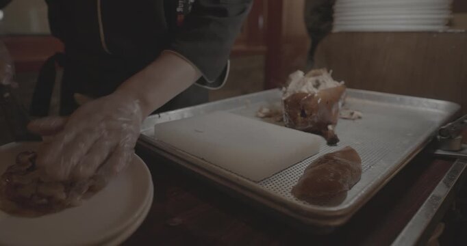 chef skillfully Peking duck slices succulent meat for an eager crowd, showcasing expertise.