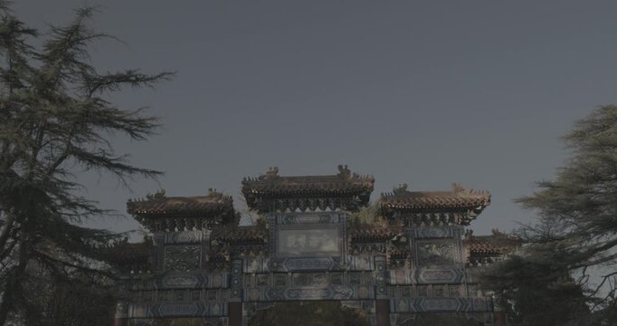 Beijing, China. Doves birds flying above Gate to ancient Lama Temple.