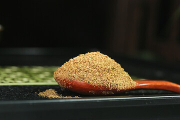 Ground Spice Powder on Red Wooden Spoon - Cooking Seasoning Ingredient