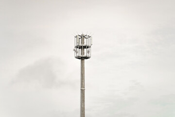 Steel communication tower piercing the somber sky on a overcast day, connecting the world through technology