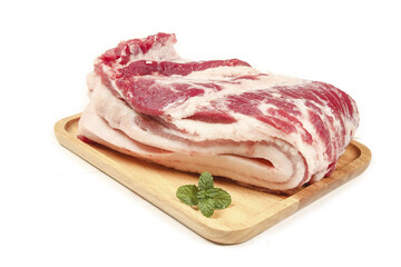 Raw Pork Belly on Wooden Board with Mint Garnish