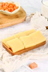 Fresh German Cheese Cubes with Red Peppers on Wooden Board