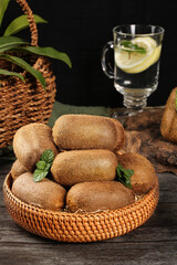 Fresh Kiwi Fruits in Basket with Water and Mint Leaves
