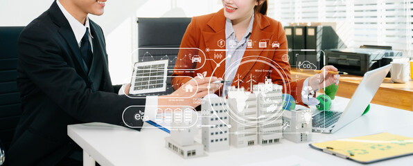 Business team reviewing eco technology with a futuristic digital interface. Green energy, sustainability, and innovation concept