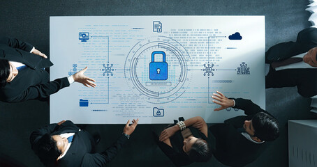 A diverse group of professionals works together at a table, discussing a cybersecurity strategy highlighted by digital data visualization and a prominent lock icon. Trope