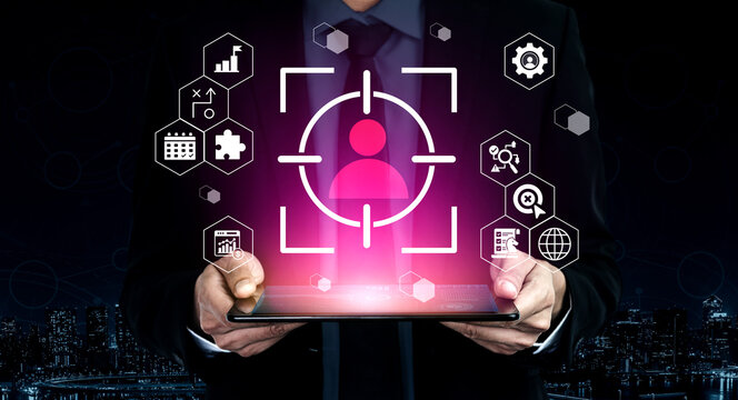 A professional businessman holds a tablet showcasing a digital target icon surrounded by analytics symbols, representing technology, innovation, and data analysis in modern business. Gantry - Powered by Adobe