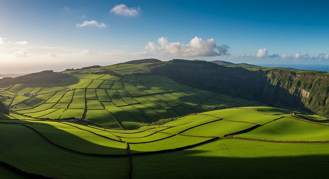 Aerial view of lush green fields and rolling hills under a bright blue sky - Powered by Adobe