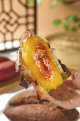 Roasted Japanese Sweet Potato with Honey Glaze - Traditional Asian Snack Food in Hands
