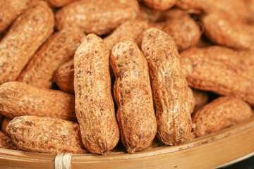 Fresh Unshelled Peanuts in Shell with Natural Brown Skin in Wooden Basket