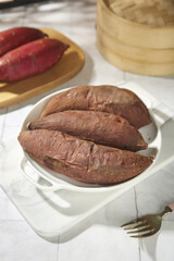 Roasted Japanese Sweet Potatoes Kintoki Yao in Ceramic Dish with Bamboo Steamer Asian Cuisine Cooking Ingredient