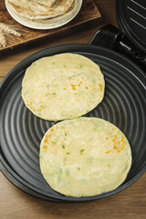Traditional Scallion Pancakes with Handmade Layers Cooking in Pan - Asian Appetizers and Panfried Food