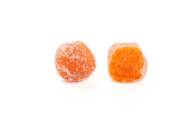 Sweet dried kumquat fruit candies coated in sugar on white background