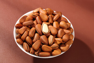Pine Nuts in Bowl Red Background Handpeeled Natural Healthy Snack Food Ingredient