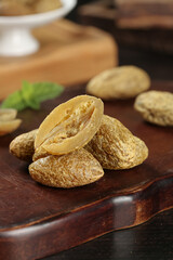 Dried Pitless Olives and Preserved Fruits on Wooden Board - Healthy Snack Food Ingredients