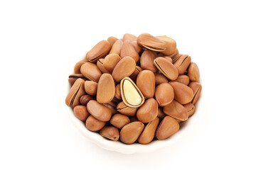 Fresh Pine Nuts in Bowl with One Cracked Open Showing Kernel - Healthy Natural Food Ingredient