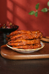 Marinated Chicken Phoenix Claws Tiger Feet Asian Delicacy Snacks on Red Background