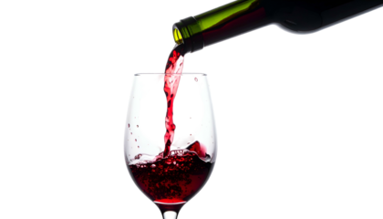 Red wine flows from a bottle into a glass against a black background