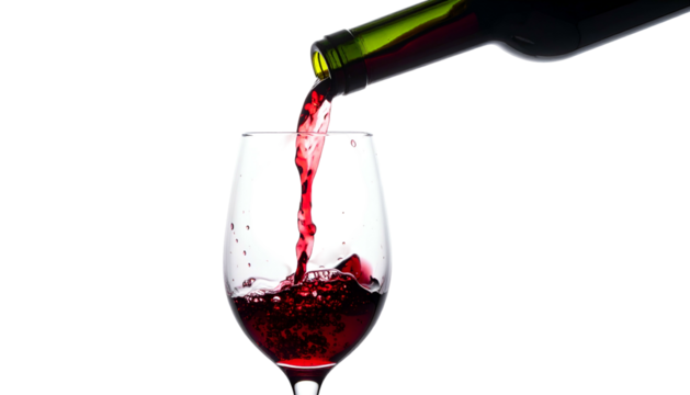 Red wine flows from a bottle into a glass against a black background