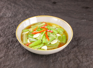 Stir Fry Chinese Squash Shouguang Style with Red Peppers and Garlic in Traditional Bowl
