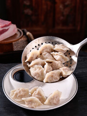 Freshly Steamed Handmade Dumplings in Metal Strainer with Soy Sauce - Traditional Asian Cuisine