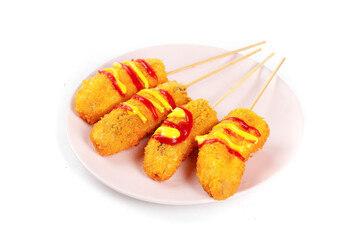 Fried Banana Skewers with Colorful Sauce on White Plate