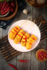 Fried Banana Skewers with Chili Sauce - Asian Street Food Appetizer on Wooden Table