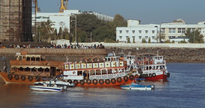 Mumbai, India. Many Boats with Tourists floating on the Arabian Sea. Tourists boats floating near Gateway of India. Cityscape skyline of Mumbai.