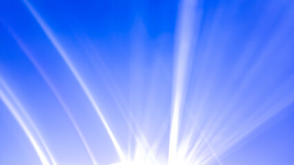 Dramatic white light rays radiate upward from a point source in the center, against a bright and...