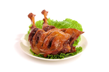 Roasted Duck with Crispy Skin and Legs on Lettuce Garnish White Background