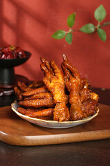 Marinated Chicken Feet in Savory Sauce - Traditional Asian Snacks on Wooden Plate