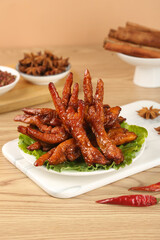 Marinated Chicken Feet in Brown Sauce with Asian Spices and Herbs on Wooden Table