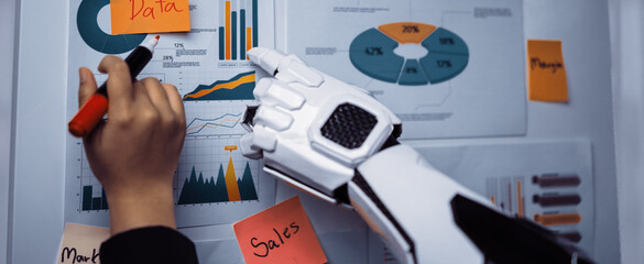 A robotic hand interacts with a business infographic, highlighting data analysis, marketing strategies, and sales metrics through vibrant charts and graphs.Noogenesis