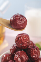 Dried Red Jujube Dates from Hetian Xinjiang China on Wooden Spoon Traditional Winter Fruit