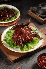 Roasted Spicy Quail with Lettuce on Wooden Board - Traditional Asian Cuisine Dish