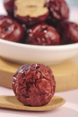 Dried Jujube Dates from Xinjiang Hetian Region on Wooden Spoon - Traditional Chinese Winter Superfood