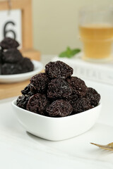 Dried Candied Plums in White Bowl with Tea - Traditional Asian Preserved Fruit Snack