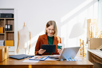 Female designer choosing a color palette while working on a creative project in a bright modern workspace.