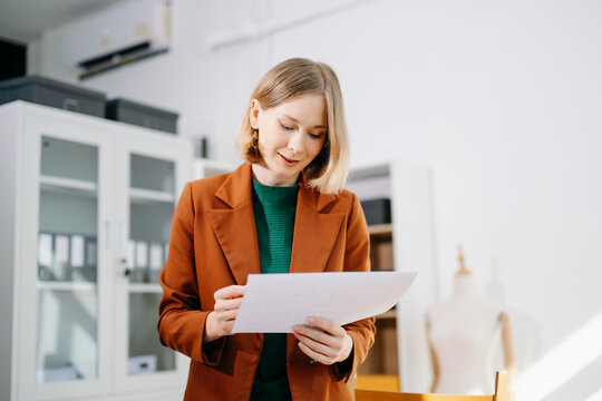 Designer selecting color palette while working on a creative branding project in a modern bright workspace.