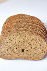 Sliced Loaf of Dark Rye Bread or Whole Grain Bread on a Kitchen Table.