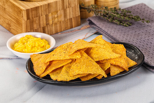 Corn nachos chips with cheese dip