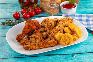 Golden crispy fried chicken mix - wings, drumsticks, nuggets and strips