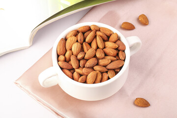Roasted Almonds in White Bowl on Pink Background