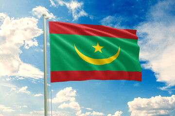 Realistic close-up of the Mauritania flag waving on a tall flagpole under a bright sky with scattered clouds, showing smooth wind motion, vivid colors, and a strong sense of national pride.
