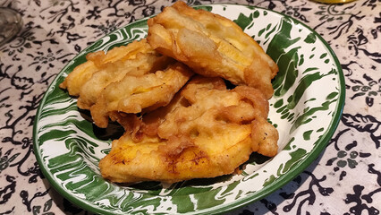Fried bananas on an antique plate, indoors in the afternoon.