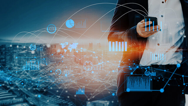 A business professional stands with a smartphone, analyzing data trends against a city skyline. Graphical representations illustrate real-time insights into analytics and metrics. Xenic