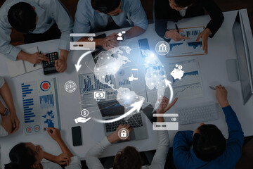 A diverse group of professionals collaborates in a modern office setting, utilizing technology and data visualization to strategize and develop innovative business solutions. Trope