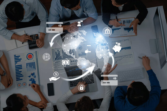 A diverse group of professionals collaborates in a modern office setting, utilizing technology and data visualization to strategize and develop innovative business solutions. Trope